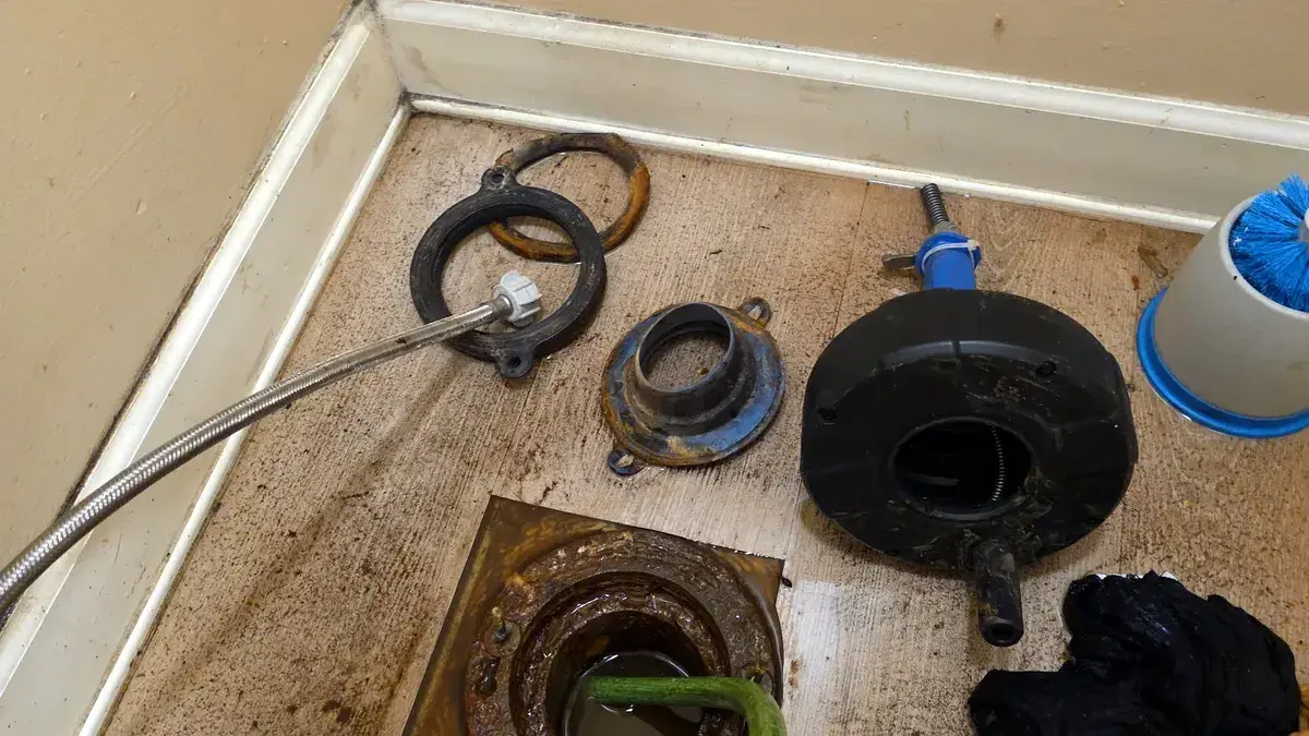 Drain cleaning cable fed through an opened indoor floor drain during service