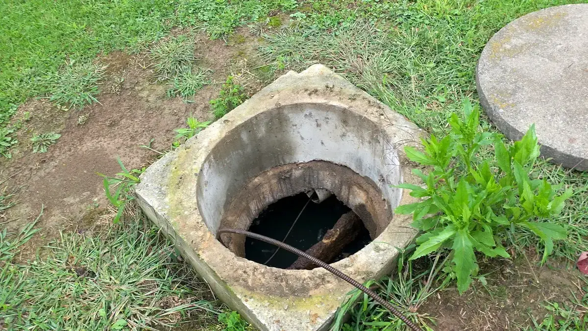 Sewer cleaning cable entering an open residential main-line access point